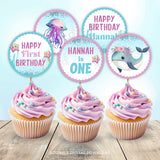 Under the Sea 1st birthday cupcake toppers, with an adorable whale and smiley jellyfish, in pretty shades of purple and blue. Perfect for a little girl's sea creature first birthday party decorations. Template to Edit in Corjl. By Tangled Tulip Designs. 