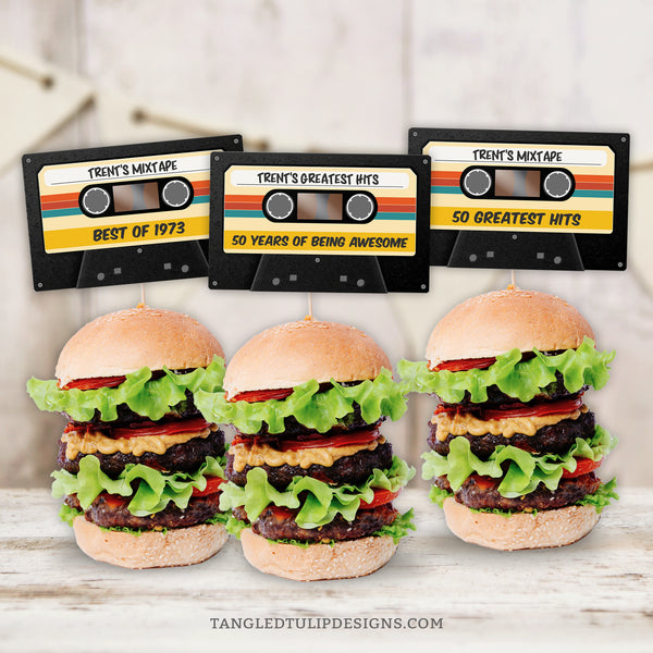 Get ready to rewind to the retro vibes with these Cassette Tape Cupcake Toppers, perfect for adding a touch of vintage flair to your mixtape party decorations. Whether adorning cupcakes or sliders, these toppers are sure to be a hit. Instant Download and Editable in Corjl. By Tangled Tulip Designs.