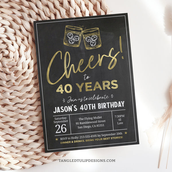 An elegant Cheers Whiskey Theme Birthday Invitation design featuring gold whiskey glasses raised for a toast on a classic chalkboard background. Perfect for celebrating a whiskey lover's 40th birthday or customizable for any age.  Tangled Tulip Designs - Birthday Invitations