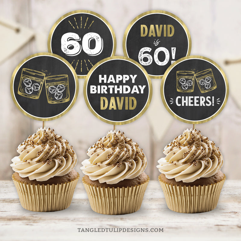 Whiskey theme 60th Birthday Cupcake or Slider Toppers! Customize with the name and age of the guest of honor for a personalized touch.&nbsp; These elegant gold and white toppers stand out against a timeless chalkboard background, making them perfect for celebrating his 60th birthday, or any age. By Tangled Tulip Designs.