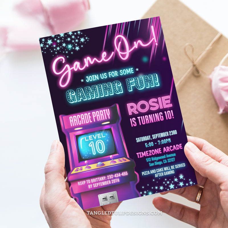 An editable Arcade party invitation for girls, in a vibrant neon glow design, featuring an arcade game, stars, and sparkles. It's Game On for some gaming fun! Template to Edit in Corjl. By Tangled Tulip Designs.