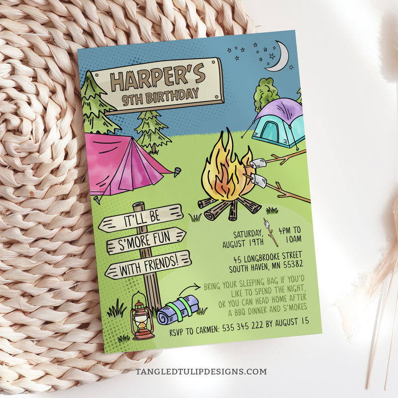 An editable S'mores Campout birthday invitation featuring a big campfire and roasting marshmallows for S'mores, with tents for camping in the background.