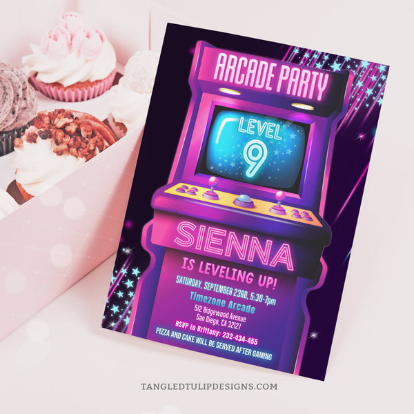 An editable Arcade Birthday party invitation for girls, with an arcade game in a vibrant neon glow design in shades of pink, purple and blue. Template to Edit in Corjl. By Tangled Tulip Designs.