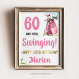 A woman Golfer 60th Birthday sign with a golf bag and golf ball on a tee. 60 and Still Swinging! Happy 60th Birthday editable sign template. Pink and Gold.