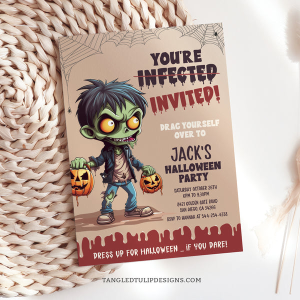 This editable Zombie Halloween party invitation features a gruesome zombie boy and creepy spiderwebs. Template to Edit in Corjl. By Tangled Tulip Designs.