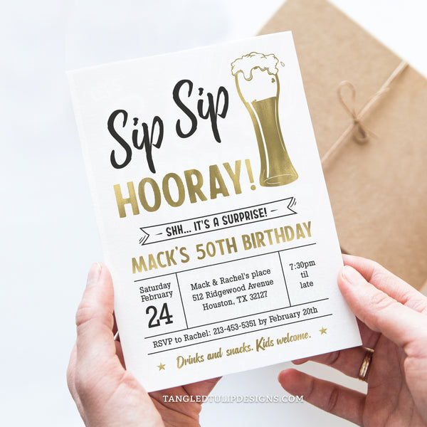 A Surprise Birthday invitation for a man in a beer theme. Sip Sip Hooray for his milestone birthday. This classic gold and white invitation, adorned with a shimmering beer, sets the perfect tone for a memorable beer-themed surprise party! Tangled Tulip Designs - Birthday Invitations