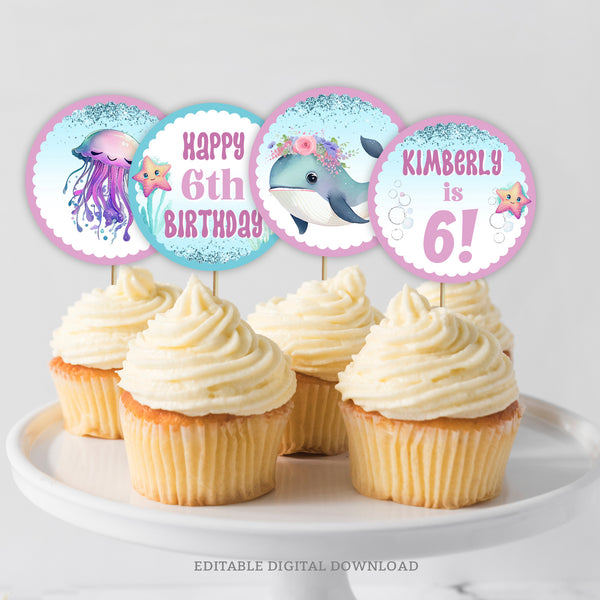 Under the Sea birthday cupcake toppers, with an adorable whale and smiley jellyfish, in pretty shades of purple and blue. Perfect for a little girl's sea creature birthday party decorations. Instant Download and Editable in Corjl. By Tangled Tulip Designs.