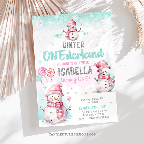 Winter ONEderland birthday invitation for a little girl's 1st birthday party, with cute snowmen and candy lollipops in the snow, and falling snowflakes. A watercolor design with glitter silver accents.  Instant Download and Editable in Corjl. By Tangled Tulip Designs.