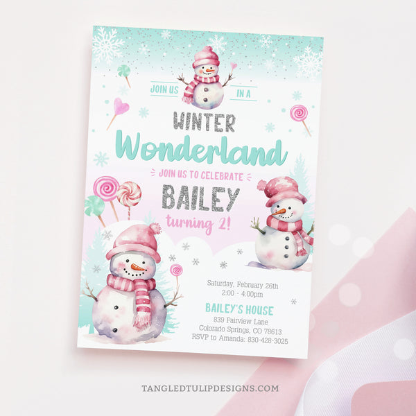 A pretty Winter Wonderland birthday invitation for girls, with cute snowmen and candy lollipops in the snow. Pastel watercolor design with glitter silver accents. Tangled Tulip Designs - Birthday Invitations