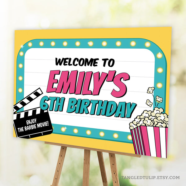 An editable Movie Party Welcome Sign for girls, in the style of a movie marquis, with popcorn and a movie clapperboard with the name of the movie. Edit all the text to personalized this sign to suit your movie event. By Tangled Tulip Designs