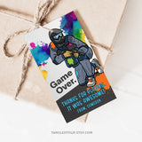 Paintball birthday Thank You tags, with a paintballer covered in paint splatter. Game Over editable paintball party tags. 