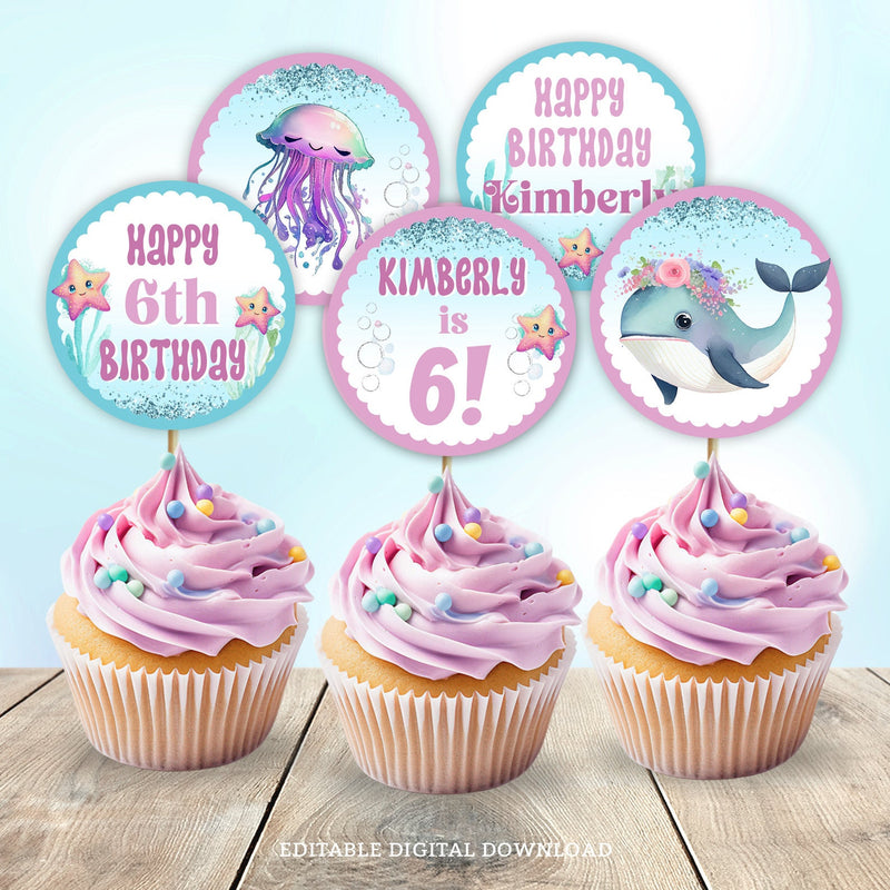 Under the Sea birthday cupcake toppers, with an adorable whale and smiley jellyfish, in pretty shades of purple and blue. Perfect for a little girl's sea creature birthday party decorations. Instant Download and Editable in Corjl. By Tangled Tulip Designs.